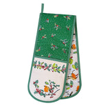 A pair of Christmas-themed oven mitts with a green and white holly pattern, featuring birds and berries, shown on a plain white background.
